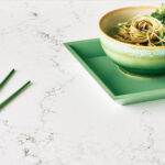 white veined counter with bowl of noodles