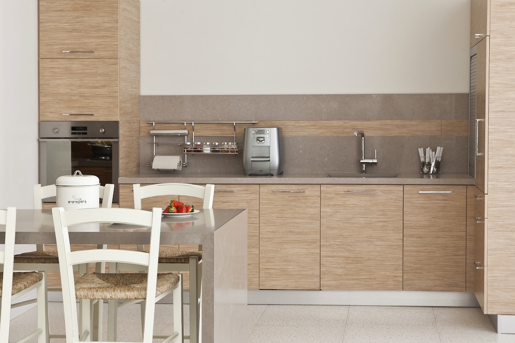 Light wood kitchen with grey stone backsplash and countertop 