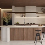 Caesarstone 5132 Celestial Sky surface in Modern kitchen with wooden cabinetry, white island, bar stools, pendant lights, and large glass doors.