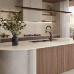 Caesarstone 5132 Celestial Sky surface in Modern kitchen with large island, sleek faucet, vase with greenery, and cityscape view outside.