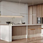 Modern minimalist kitchen with wooden cabinetry, white Caesarstone 502 Sleet porcelain island, built-in appliances, and two bar stools.