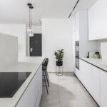 Caesarstone porcelain 504 Lumena surface in a modern kitchen with island design by Revital Marciano photography Ido Ganor
