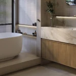 Caesarstone porcelain 506 Mirabel surface in Modern bathroom with freestanding bathtub, marble countertop, wooden cabinets, large window, and minimalist decor.