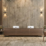Modern reception area with wooden furniture, two iMacs, pendant lights, and neutral decor with Caesarstone porcelain 513 Striata flooring and cladding