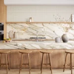 Modern kitchen with Caesarstone porcelain 536 Antikella surface countertops, wooden cabinets, four stools, and decorative vases on shelf.