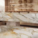 Caesarstone porcelain 536_Antikella surface in a countertop and bench with various types of bread and wheat stalks in rustic setting.